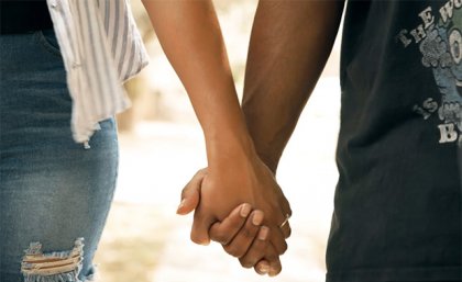 a close up of the hands of two people holding hands